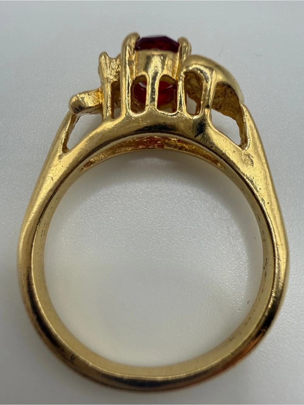 Gold Ring with Oval Red Center Stone and Clear Accent Stones